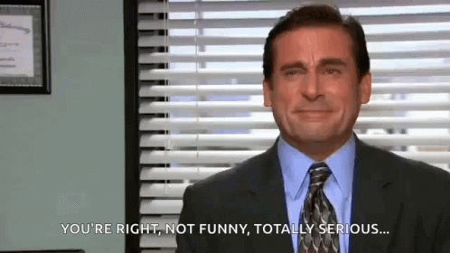 A Man In A Suit And Tie Is Making A Funny Face In Front Of A Window . GIF