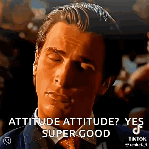 a man in a suit and tie is making a funny face .