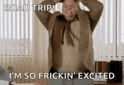A Man In A Suit And Tie Is Making A Funny Face While Holding His Head . GIF