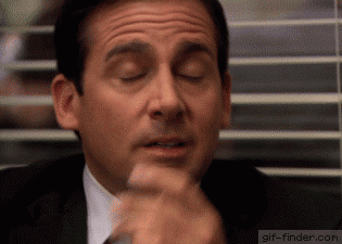A Man In A Suit And Tie Is Making A Funny Face With His Eyes Closed GIF