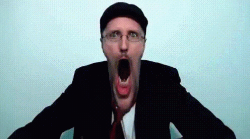 A Man In A Suit And Tie Is Making A Funny Face With His Mouth Open GIF