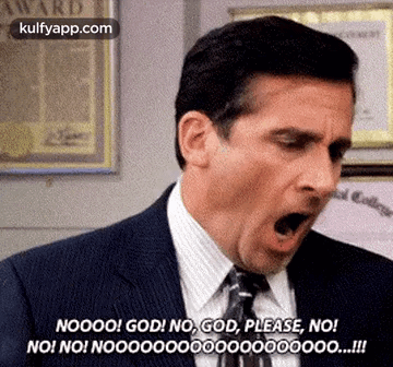 A Man In A Suit And Tie Is Making A Funny Face With His Mouth Wide Open . GIF