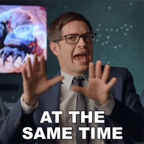 A Man In A Suit And Tie Is Making A Funny Face With The Words At The Same Time Behind Him GIF