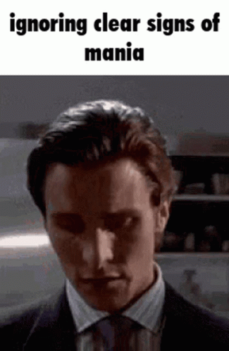 A Man In A Suit And Tie Is Making A Funny Face . GIF