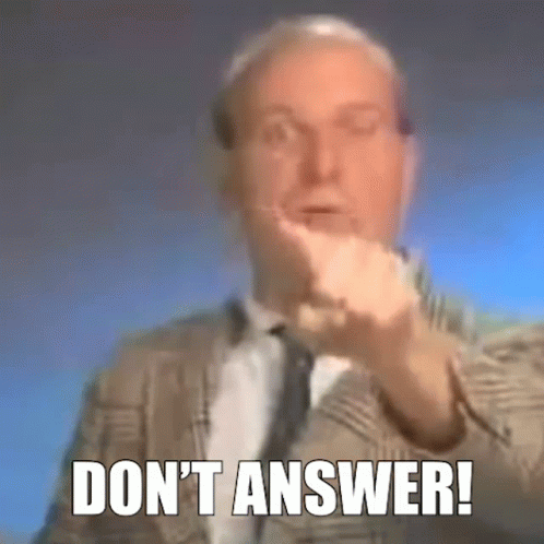 a man in a suit and tie is making a gesture with his hand and the words `` do n't answer '' .