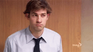 A Man In A Suit And Tie Is Making A Sad Face . GIF