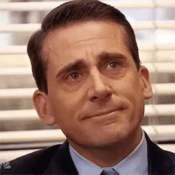 A Man In A Suit And Tie Is Making A Sad Face In Front Of A Window . GIF