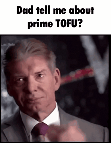 A Man In A Suit And Tie Is Pointing At The Camera With The Words Dad Tell Me About Prime Tofu GIF