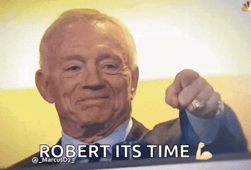 A Man In A Suit And Tie Is Pointing At The Camera With The Words " Robert Its Time " Below Him GIF