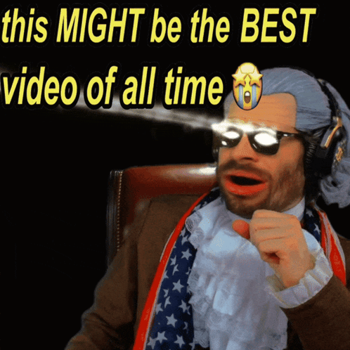 A Man In A Suit And Tie Is Pointing At The Camera With The Words " This Might Be The Best Video Of All Time " Behind Him GIF