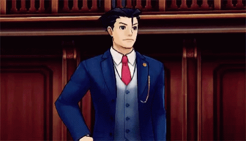 a man in a suit and tie is pointing his finger at the camera .