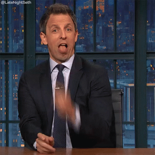 A Man In A Suit And Tie Is Pointing His Finger At The Camera GIF