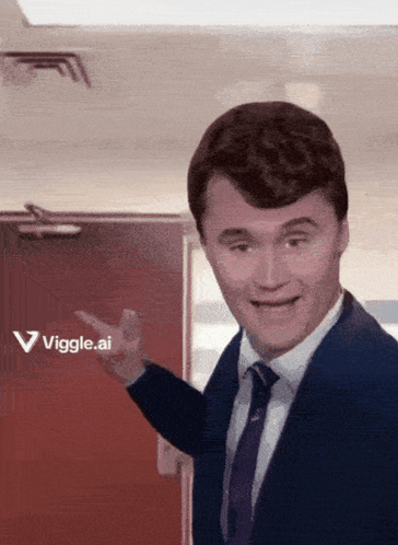 A Man In A Suit And Tie Is Pointing To A Red Door That Says Vigge.ai GIF