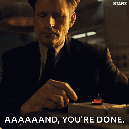A Man In A Suit And Tie Is Pressing A Red Button And Says " Aaaand You 'Re Done " GIF