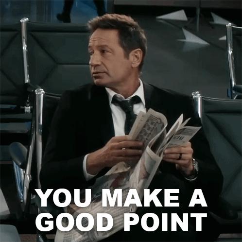 A Man In A Suit And Tie Is Reading A Newspaper With The Words " You Make A Good Point " Above Him GIF