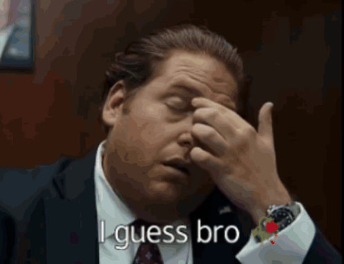 A Man In A Suit And Tie Is Rubbing His Forehead And Says " I Guess Bro " In White Letters GIF