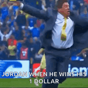 a man in a suit and tie is running on a field with his arms outstretched .