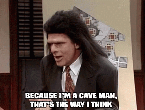 A Man In A Suit And Tie Is Saying `` Because I 'M A Cave Man That 'S The Way I Think '' GIF