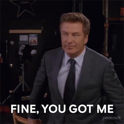 A Man In A Suit And Tie Is Saying " Fine You Got Me " GIF