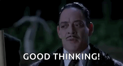 A Man In A Suit And Tie Is Saying `` Good Thinking '' In A Movie . GIF