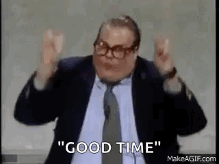 A Man In A Suit And Tie Is Saying `` Good Time '' With His Arms In The Air . GIF