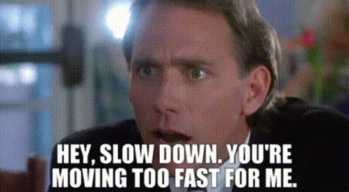 A Man In A Suit And Tie Is Saying `` Hey , Slow Down . You 'Re Moving Too Fast For Me . '' GIF