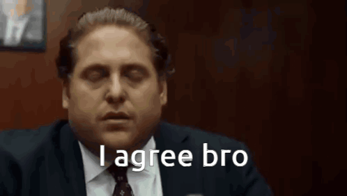 A Man In A Suit And Tie Is Saying `` I Agree Bro '' While Sitting In A Chair . GIF