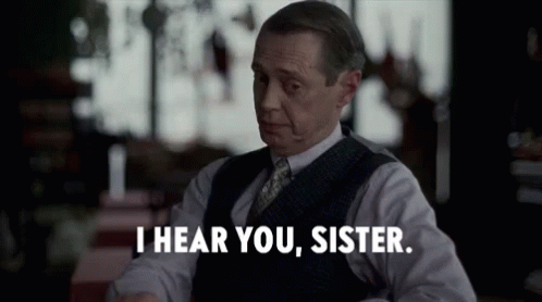 A Man In A Suit And Tie Is Saying I Hear You Sister . GIF