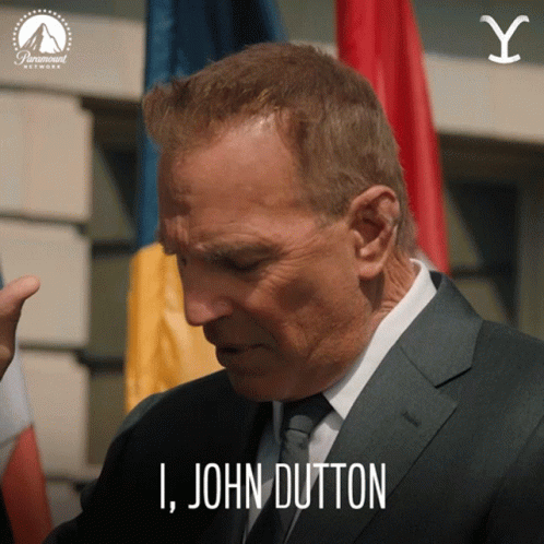 A Man In A Suit And Tie Is Saying " I John Dutton " GIF
