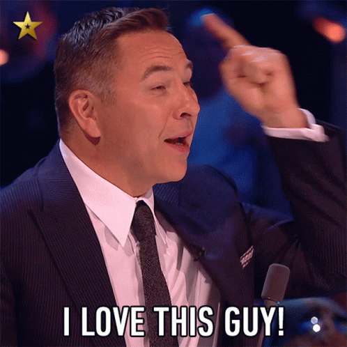 A Man In A Suit And Tie Is Saying " I Love This Guy " GIF