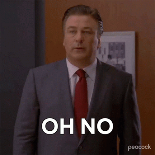 A Man In A Suit And Tie Is Saying Oh No . GIF