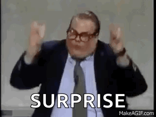 A Man In A Suit And Tie Is Saying Surprise . GIF