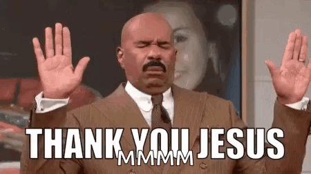 A Man In A Suit And Tie Is Saying Thank You Jesus With His Hands In The Air . GIF