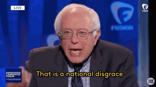 A Man In A Suit And Tie Is Saying That Is A National Disgrace . GIF