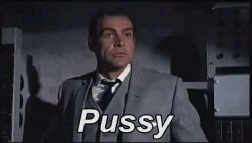 A Man In A Suit And Tie Is Saying The Word Pussy . GIF