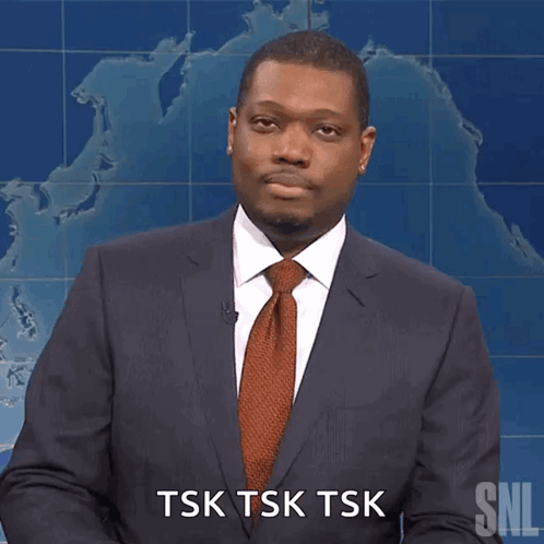 A Man In A Suit And Tie Is Saying Tsk Tsk Tsk GIF
