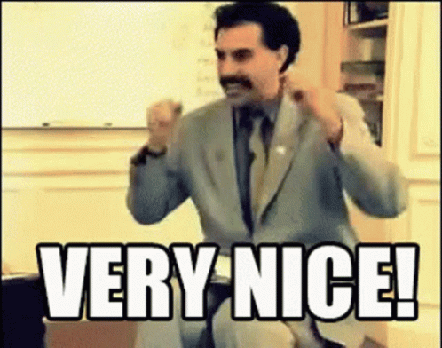 A Man In A Suit And Tie Is Saying Very Nice . GIF