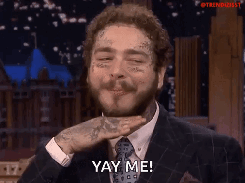 A Man In A Suit And Tie Is Saying Yay Me GIF