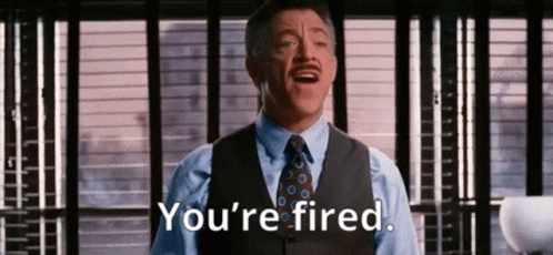 A Man In A Suit And Tie Is Saying `` You 'Re Fired '' In Front Of A Window . GIF