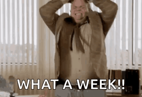 A Man In A Suit And Tie Is Screaming With His Hands On His Head And Says `` What A Week ! '' GIF