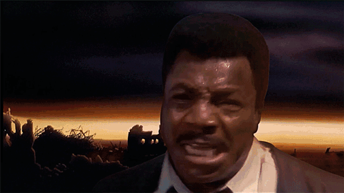 A Man In A Suit And Tie Is Screaming With His Mouth Open GIF