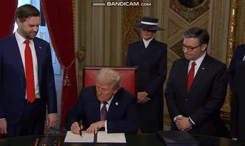 A Man In A Suit And Tie Is Signing A Document While Another Man Watches GIF