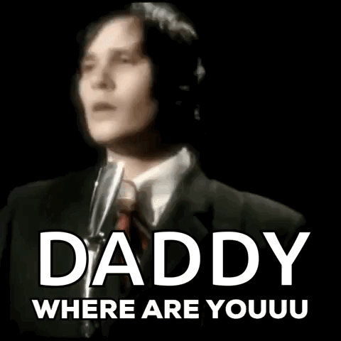 A Man In A Suit And Tie Is Singing Into A Microphone With The Words Daddy Where Are Youu Written Below Him GIF