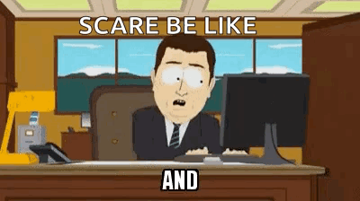 A Man In A Suit And Tie Is Sitting At A Desk In Front Of A Computer Monitor . GIF