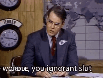 A Man In A Suit And Tie Is Sitting At A Desk In Front Of A Map And Clocks . GIF