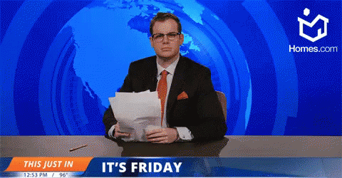 A Man In A Suit And Tie Is Sitting At A Desk In Front Of A Screen That Says " It 'S Friday " GIF