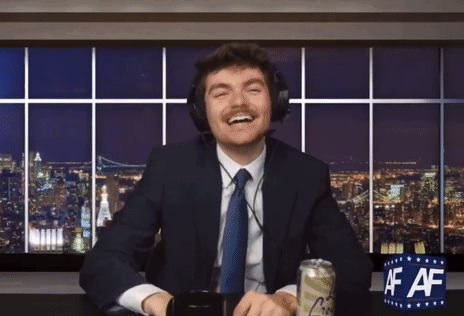A Man In A Suit And Tie Is Sitting At A Desk With A Can Of Beer And A Sign That Says Af Af GIF