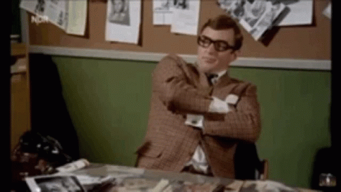 Man In Suit Sitting At Desk With Crossed Arms GIF