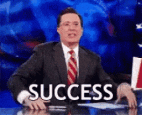 A Man In A Suit And Tie Is Sitting At A Desk With The Word Success In Front Of Him . GIF