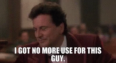 A Man In A Suit And Tie Is Sitting At A Table And Says `` I Got No More Use For This Guy '' . GIF